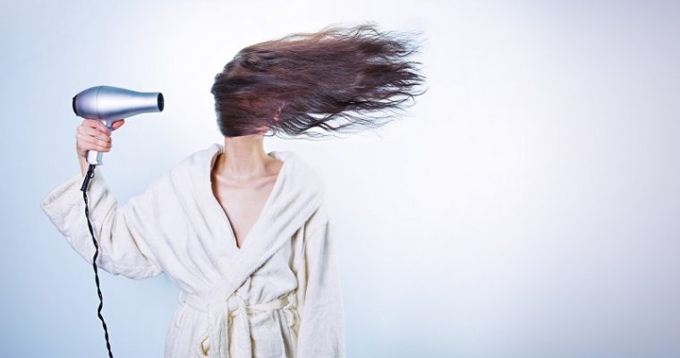 Woman blow drying her hair
