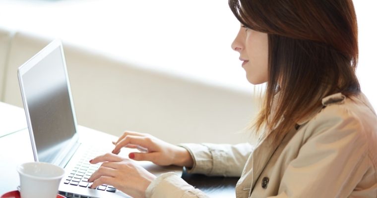 Female blogger working on laptop