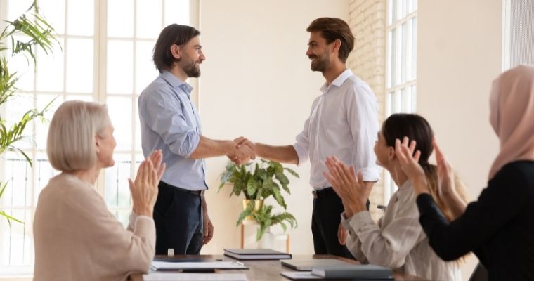 A boss shaking an employee's hand