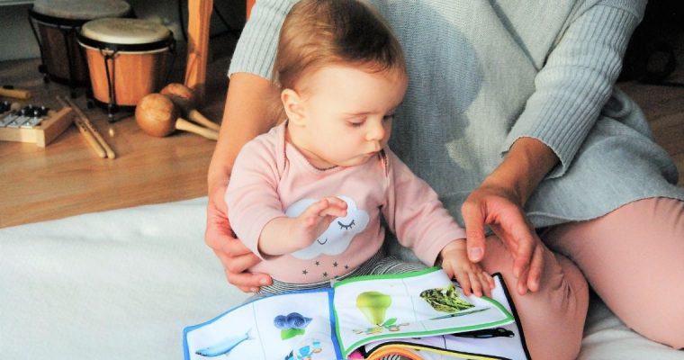 A baby looking at a book