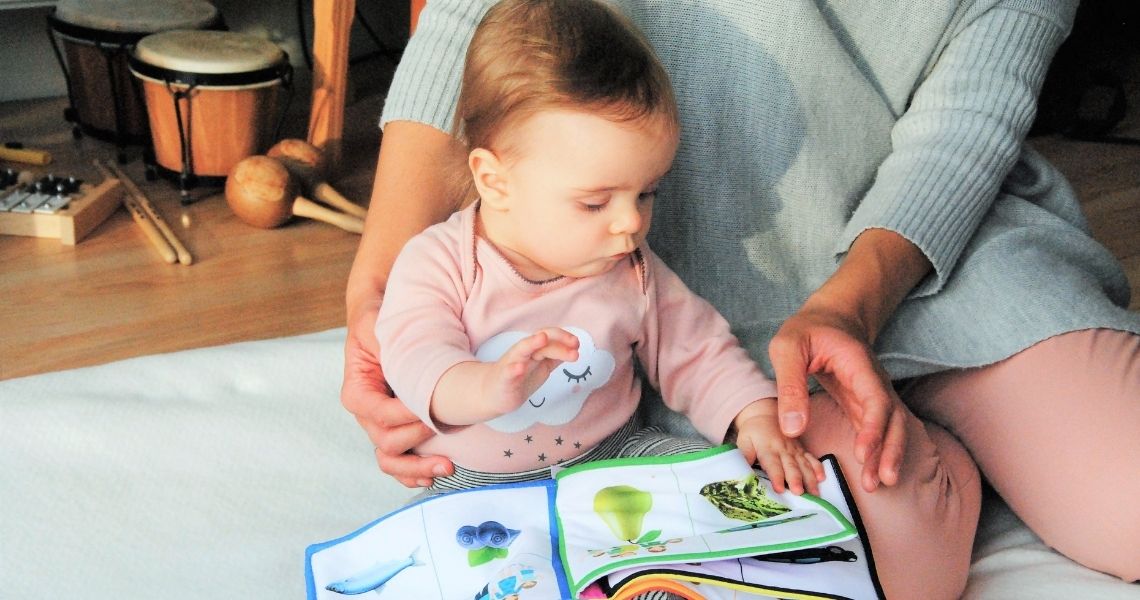 A baby looking at a book