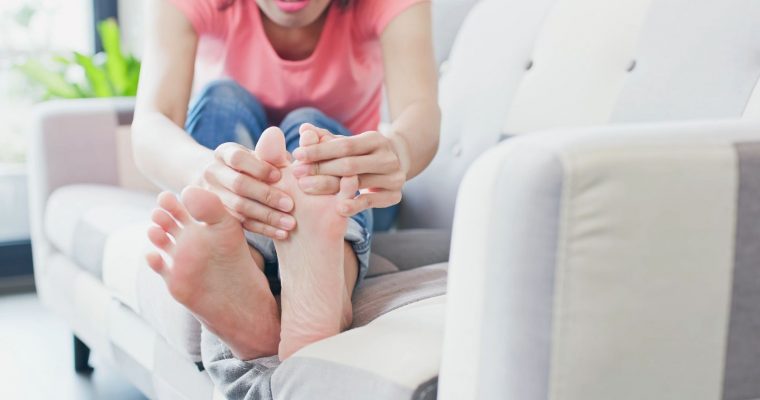 Woman looking between her toes at her athlete's foot