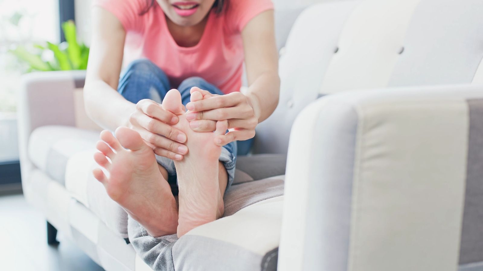Woman looking between her toes at her athlete's foot