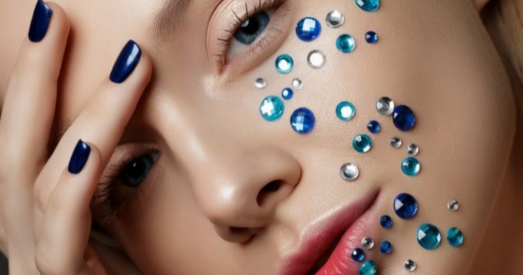 Blue crystals on a woman's cheek