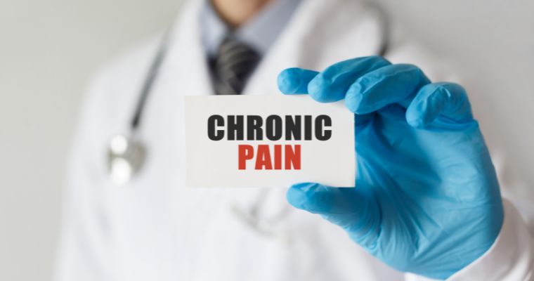 Doctor holding a card with text Chronic Pain